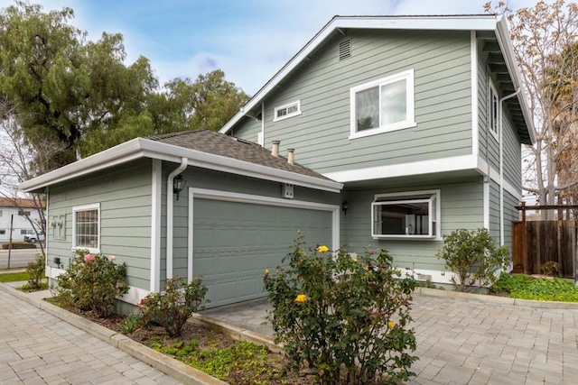 view of side of property with a garage