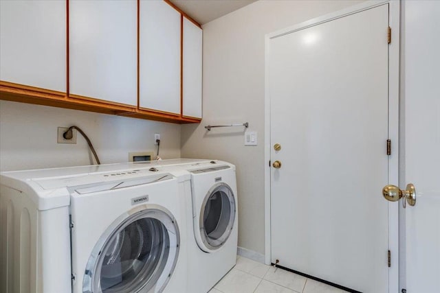 laundry room with independent washer and dryer, cabinets, and light tile patterned flooring