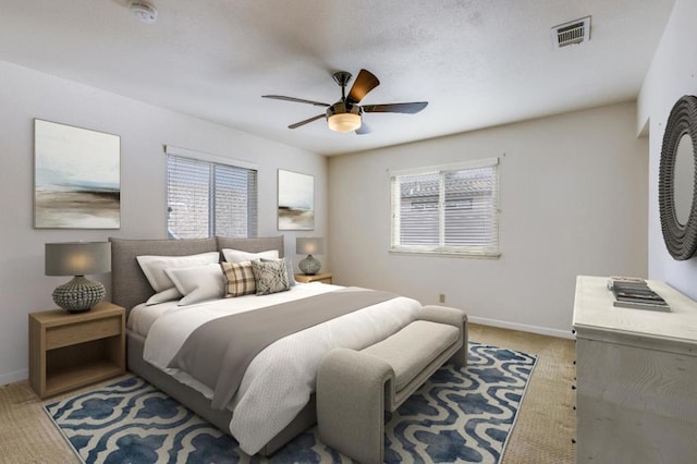 bedroom featuring light colored carpet and ceiling fan