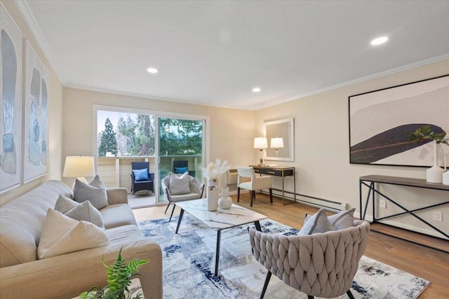 living room with crown molding, light wood-type flooring, and a baseboard heating unit