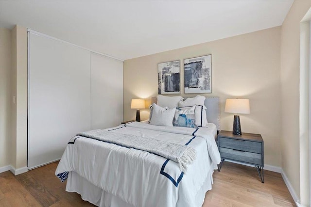 bedroom featuring a closet and light wood-type flooring