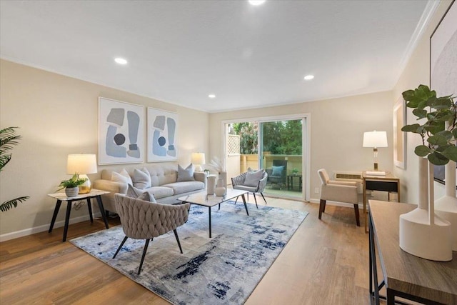 living room with ornamental molding and hardwood / wood-style floors