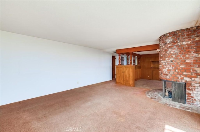 unfurnished living room featuring a brick fireplace and carpet floors