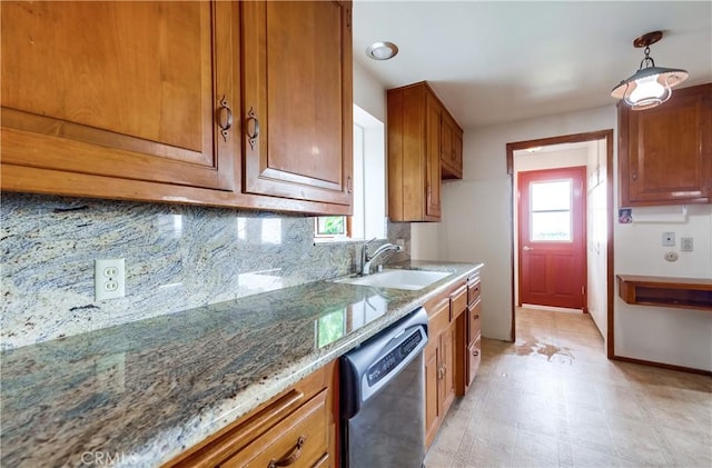 kitchen featuring pendant lighting, sink, dishwasher, light stone counters, and tasteful backsplash