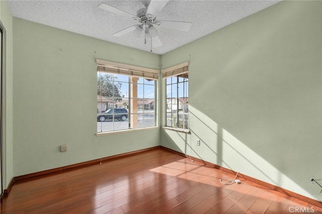 spare room featuring ceiling fan, a textured ceiling, and light hardwood / wood-style floors