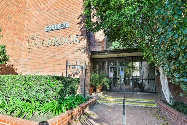 entrance to property with brick siding