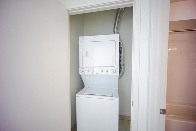 washroom featuring stacked washer and clothes dryer