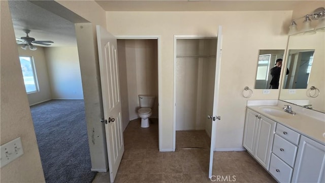 bathroom featuring ceiling fan, tile patterned floors, vanity, and toilet