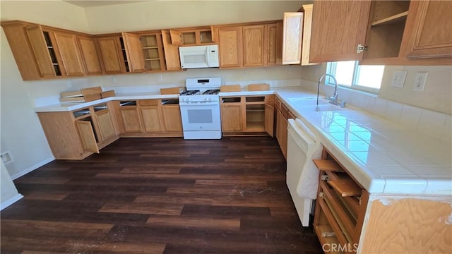 kitchen featuring dark wood-type flooring, white appliances, and sink