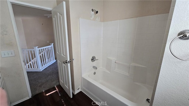 bathroom with wood-type flooring and shower / bath combination