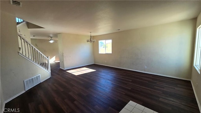 unfurnished living room featuring dark hardwood / wood-style floors and a chandelier