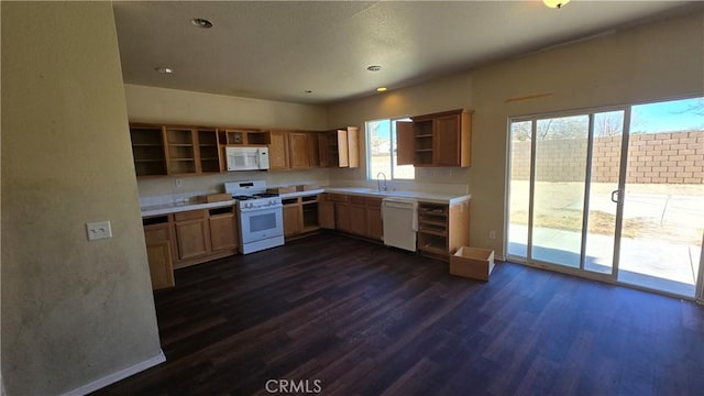 kitchen featuring white appliances, dark hardwood / wood-style floors, and sink