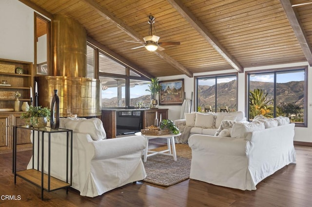 living room with dark hardwood / wood-style flooring, a mountain view, and vaulted ceiling with beams