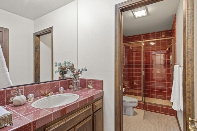 bathroom featuring walk in shower, vanity, and toilet