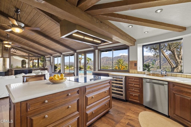 kitchen featuring light hardwood / wood-style floors, black electric cooktop, a mountain view, stainless steel dishwasher, and beverage cooler