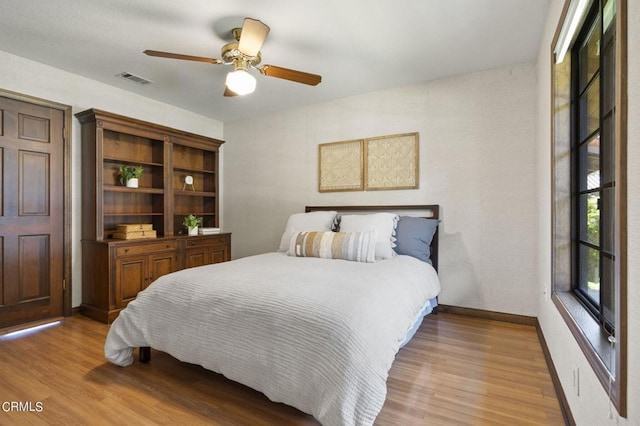 bedroom with ceiling fan and light hardwood / wood-style flooring