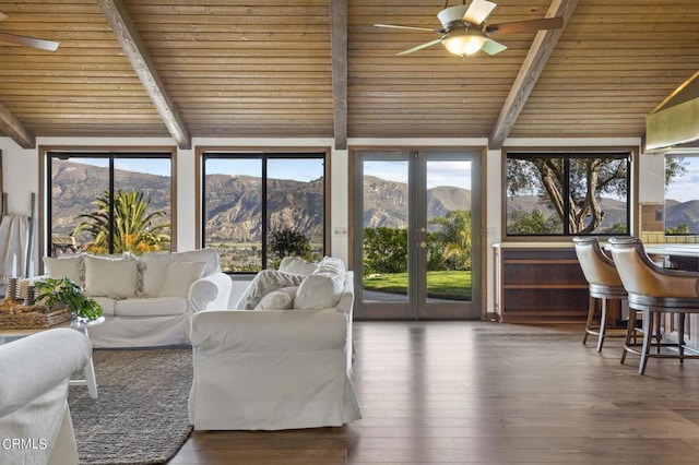 sunroom / solarium featuring wooden ceiling, plenty of natural light, a mountain view, and vaulted ceiling with beams