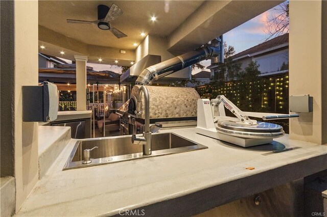 kitchen with a ceiling fan and a sink