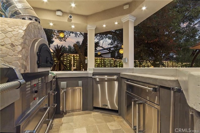 patio terrace at dusk with an outdoor kitchen