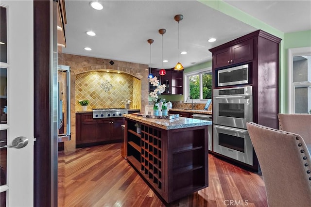 kitchen featuring light stone counters, decorative backsplash, recessed lighting, stainless steel appliances, and open shelves