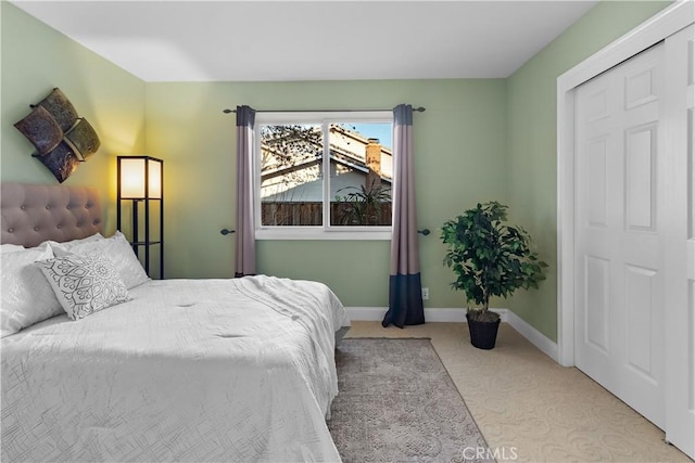 bedroom featuring carpet and baseboards