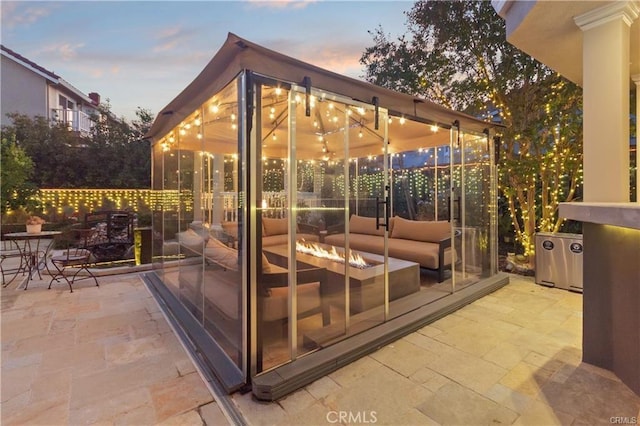 view of patio / terrace featuring an outdoor living space with a fire pit and outdoor dining space