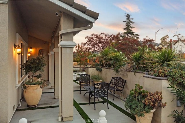 view of patio terrace at dusk