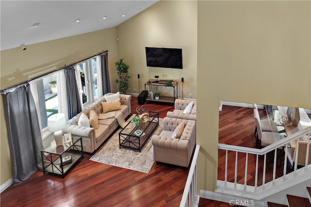 living area featuring high vaulted ceiling, wood finished floors, recessed lighting, stairway, and baseboards