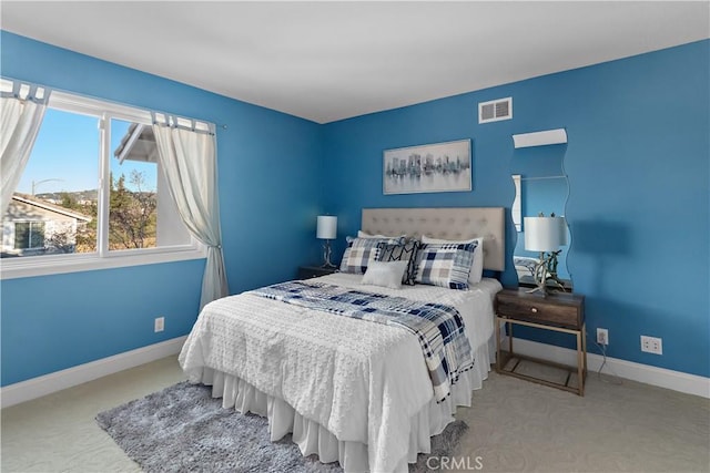 bedroom with visible vents, carpet, and baseboards