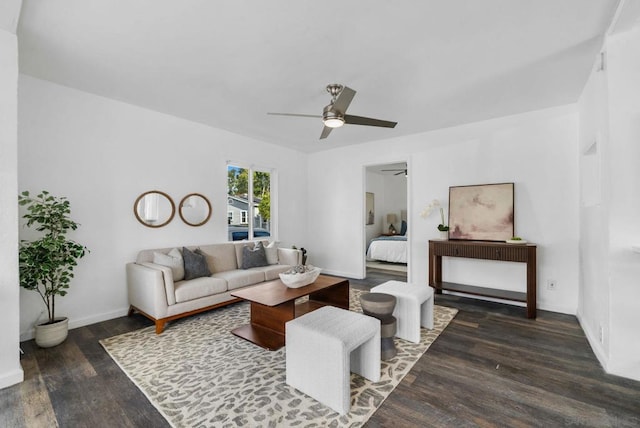 living room with dark wood-type flooring and ceiling fan