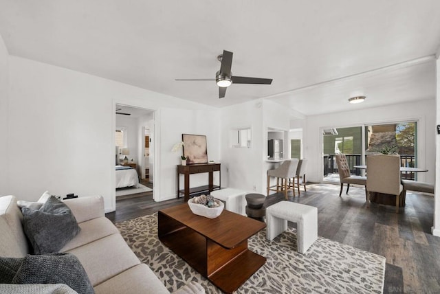 living room with ceiling fan and dark hardwood / wood-style flooring