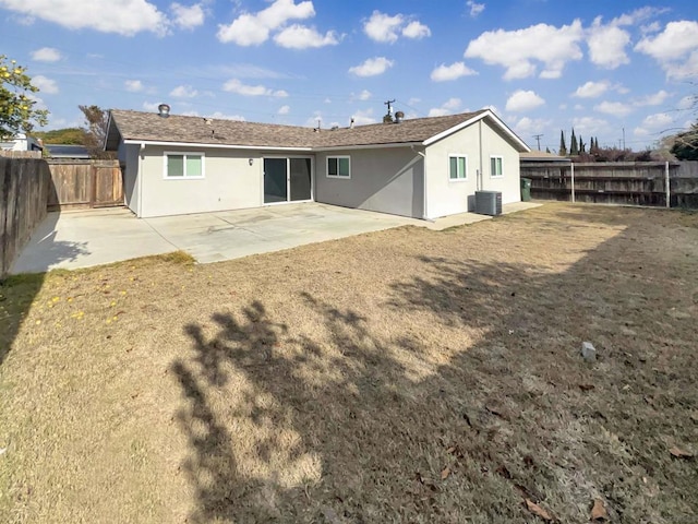 rear view of property with cooling unit and a patio area