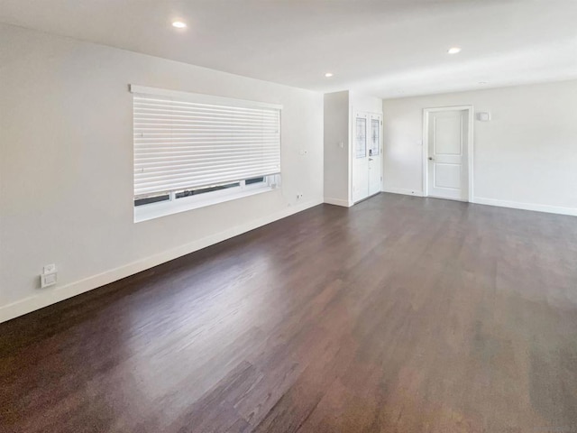 unfurnished living room featuring dark hardwood / wood-style flooring