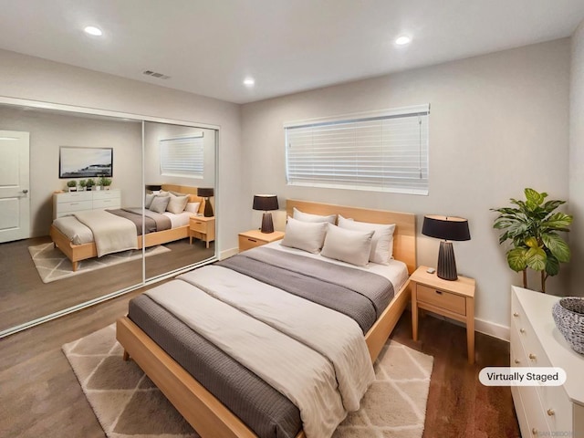 bedroom with dark wood-type flooring