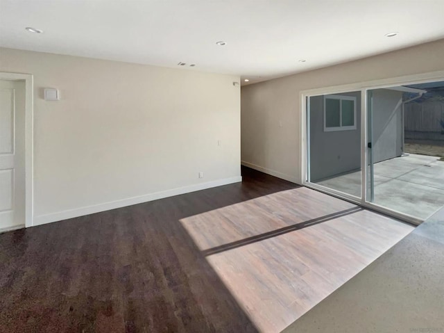 unfurnished room featuring dark wood-type flooring