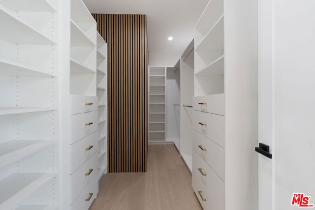 walk in closet with light wood-type flooring