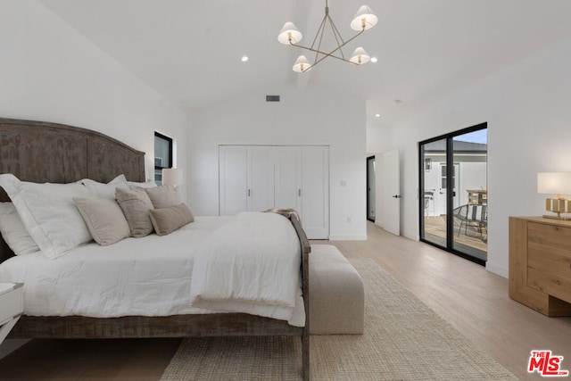 bedroom featuring access to exterior, high vaulted ceiling, a notable chandelier, light hardwood / wood-style floors, and a closet