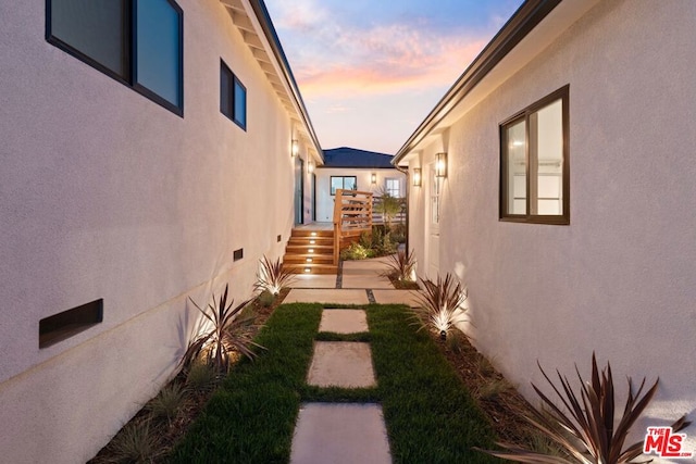 property exterior at dusk with a patio area