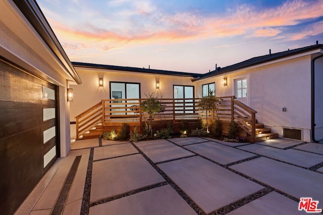 view of patio terrace at dusk