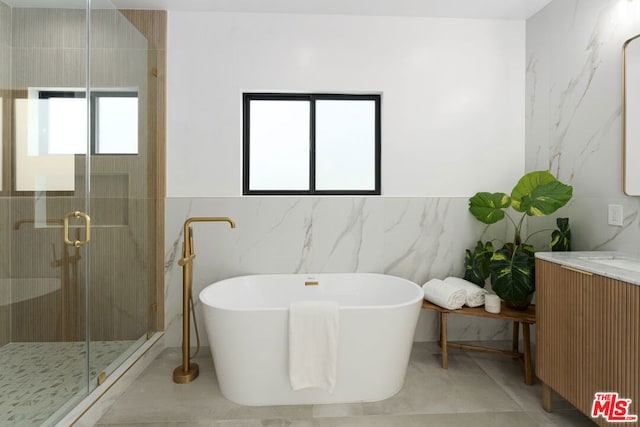 bathroom with vanity, radiator heating unit, plus walk in shower, and tile walls