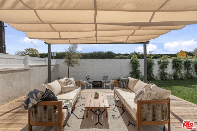 view of patio / terrace featuring a wooden deck, an outdoor living space with a fire pit, and a pergola