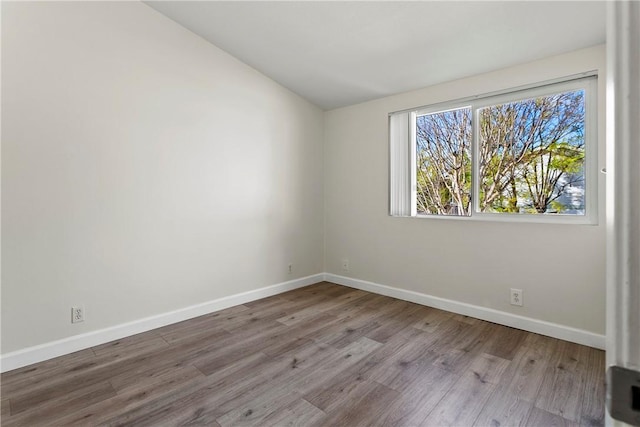 empty room with light hardwood / wood-style flooring