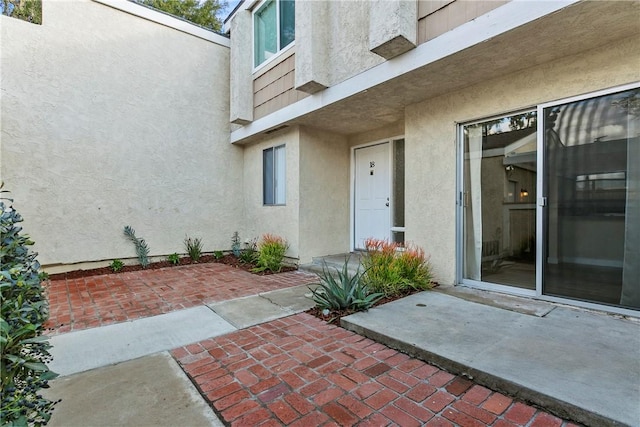 doorway to property with a patio