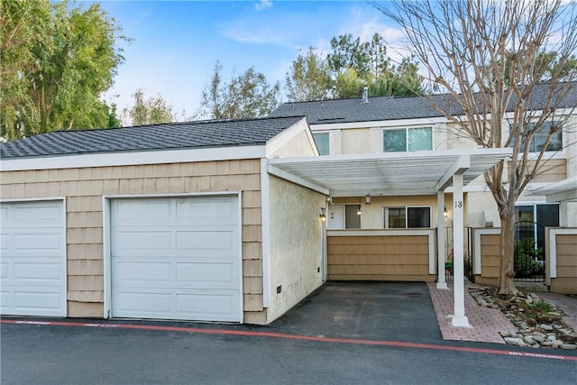 view of front facade with a carport and a garage