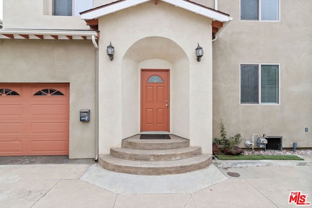 view of exterior entry with a garage