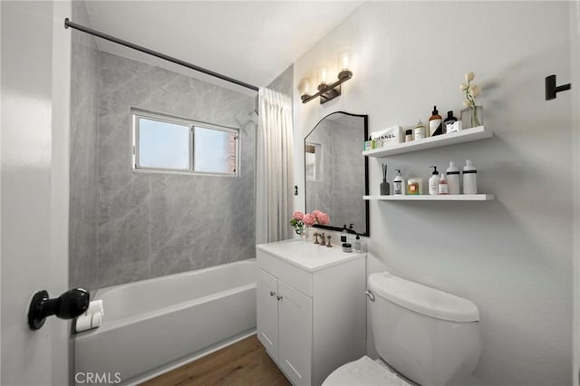 full bathroom featuring vanity, tiled shower / bath combo, toilet, and hardwood / wood-style flooring