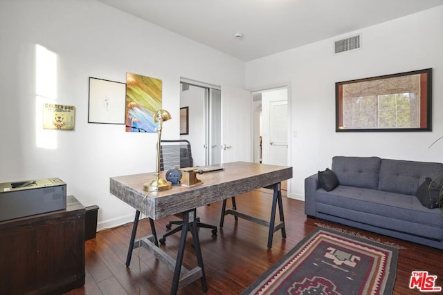 home office with dark hardwood / wood-style flooring