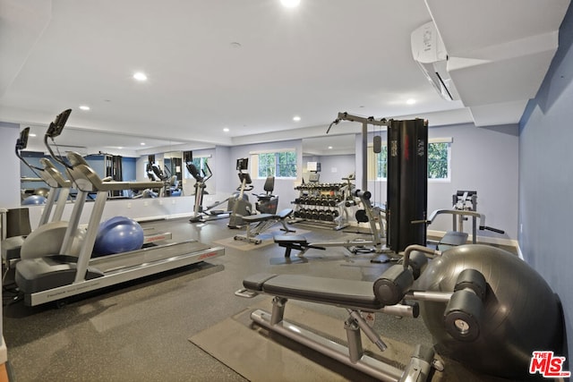 exercise room featuring a wall unit AC