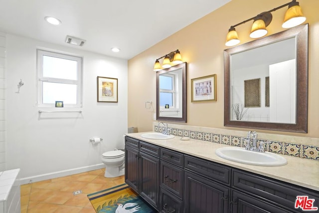 bathroom featuring tile patterned flooring, vanity, and toilet