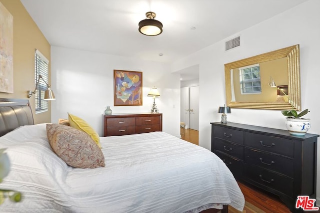 bedroom with dark hardwood / wood-style flooring